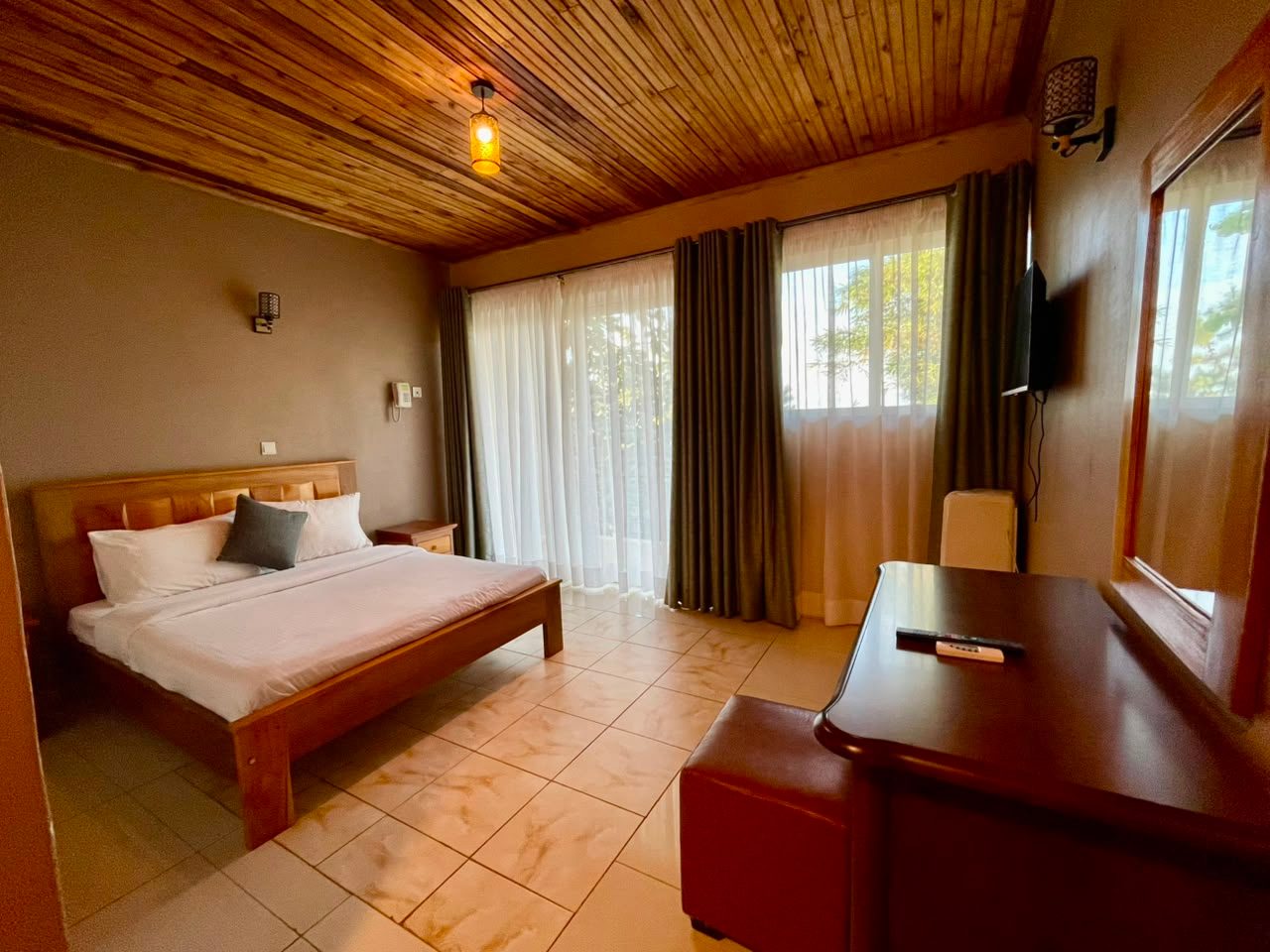 Deluxe Room timber ceiling and double bed